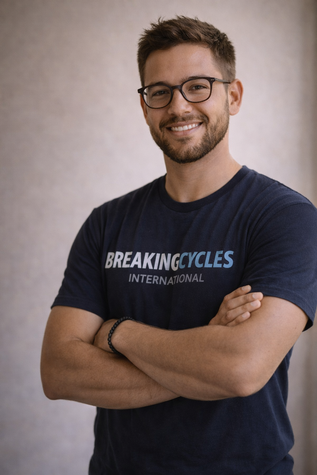 Caucasian Youth mentor wearing a Breaking Cycles International tee shirt standing professionally.
