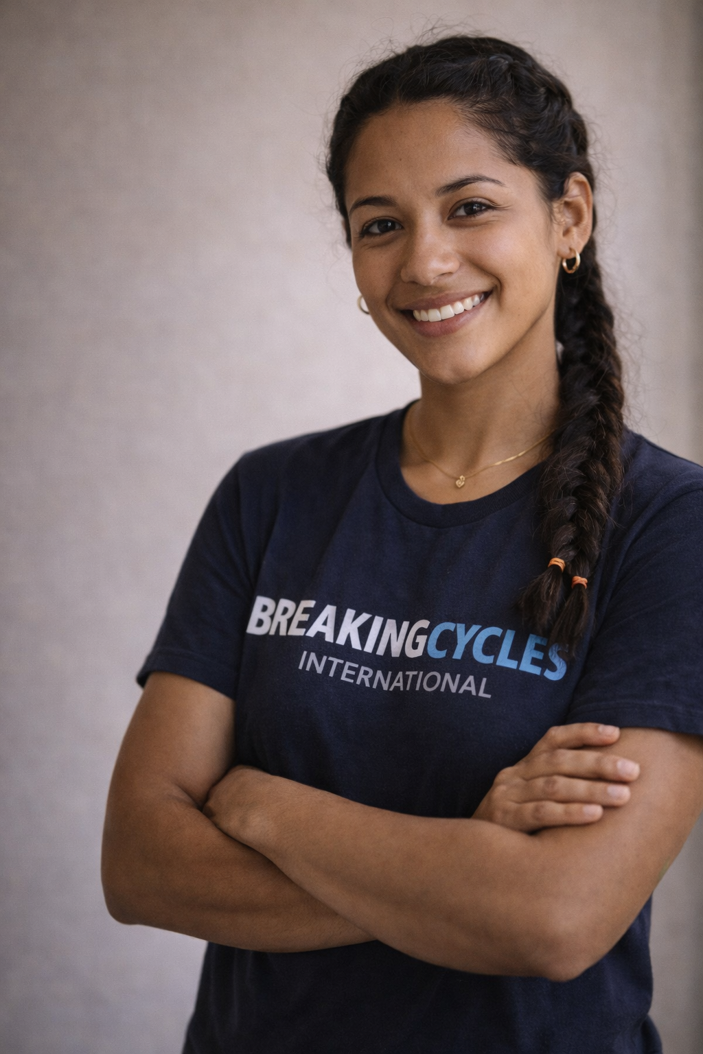 Peruvian Youth mentor wearing a Breaking Cycles International tee shirt standing professionally.